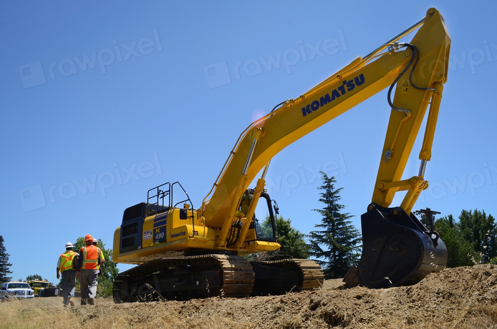 Excavator and construction crew working on a job site